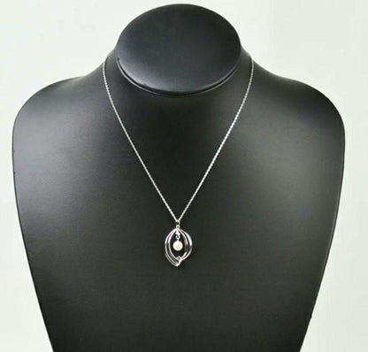 Set of four including Mikimoto silver pearl necklace, Nina Ricci necklace, Nina Ricci handkerchief, and cosmetic item