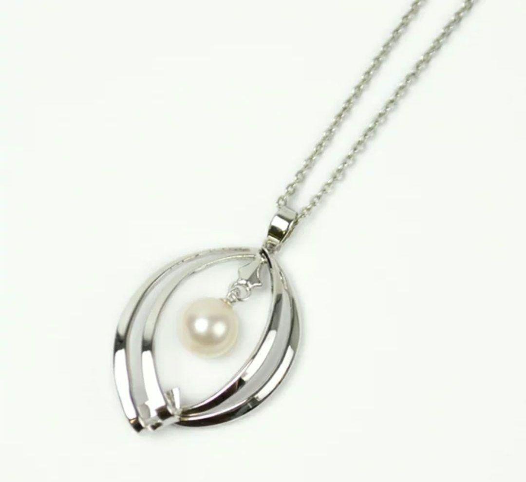 Set of four including Mikimoto silver pearl necklace, Nina Ricci necklace, Nina Ricci handkerchief, and cosmetic item