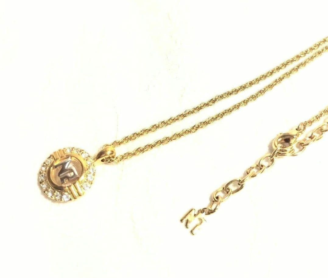 Set of four including Mikimoto silver pearl necklace, Nina Ricci necklace, Nina Ricci handkerchief, and cosmetic item