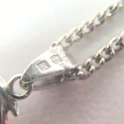 Set of four including Mikimoto silver pearl necklace, Nina Ricci necklace, Nina Ricci handkerchief, and cosmetic item