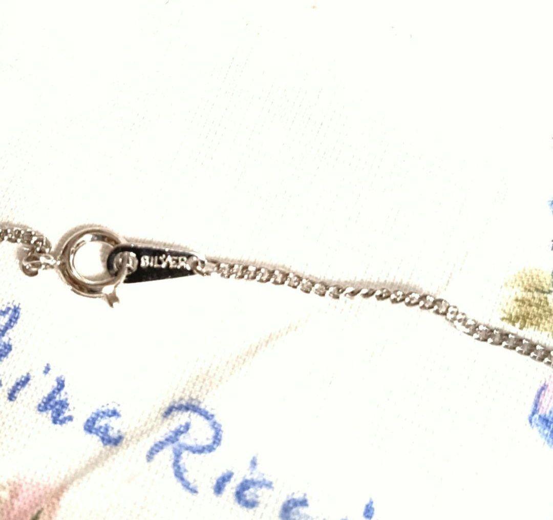Set of four including Mikimoto silver pearl necklace, Nina Ricci necklace, Nina Ricci handkerchief, and cosmetic item