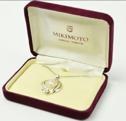 Set of four including Mikimoto silver pearl necklace, Nina Ricci necklace, Nina Ricci handkerchief, and cosmetic item