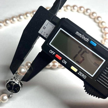 Akoya pearl necklace with 7.5-8.0mm white pearls and silver clasp displayed on white background