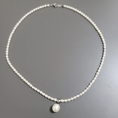 Suzunoya pearl necklace with small oval Akoya pearls and 925 silver clasp on white background