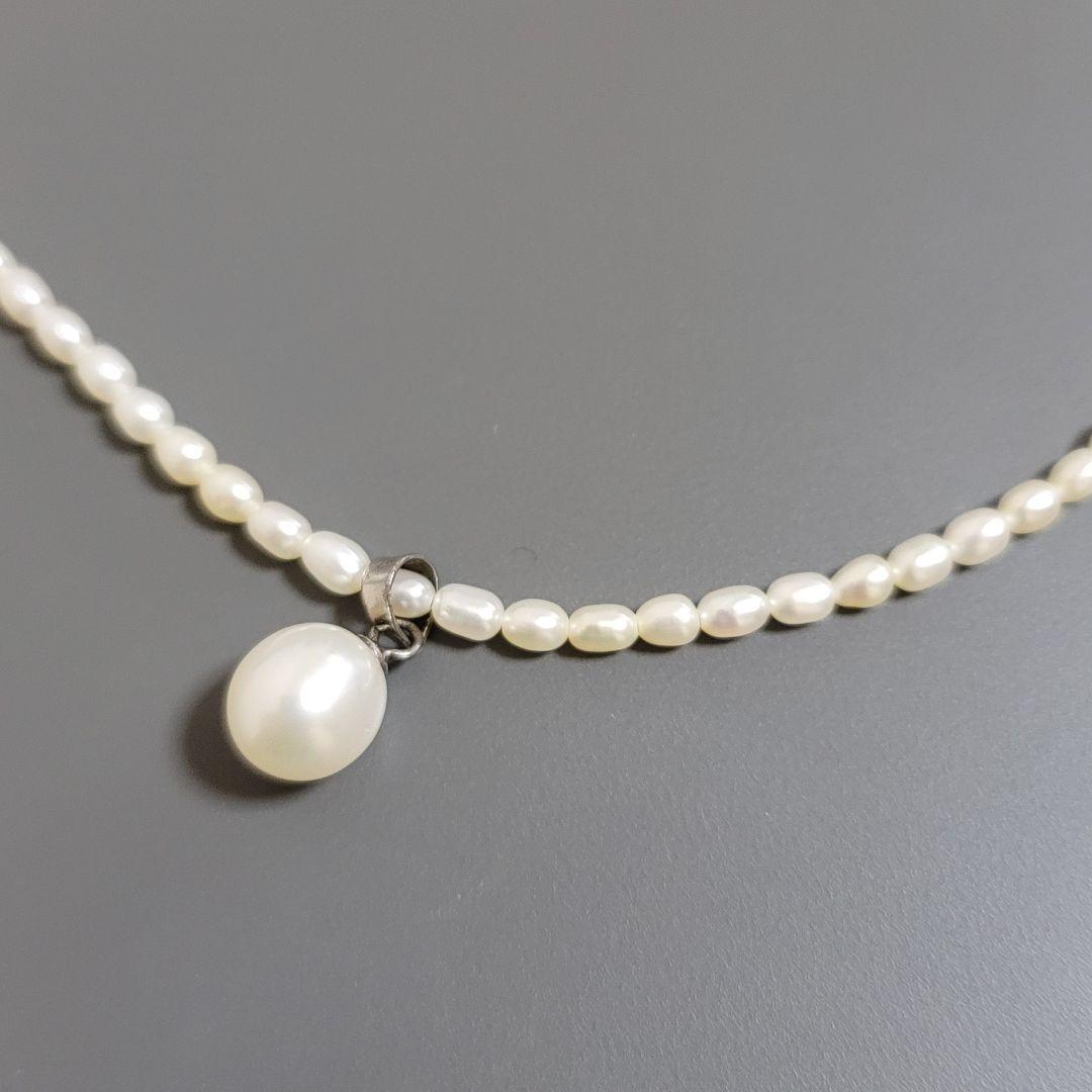 Suzunoya pearl necklace with small oval Akoya pearls and 925 silver clasp on white background