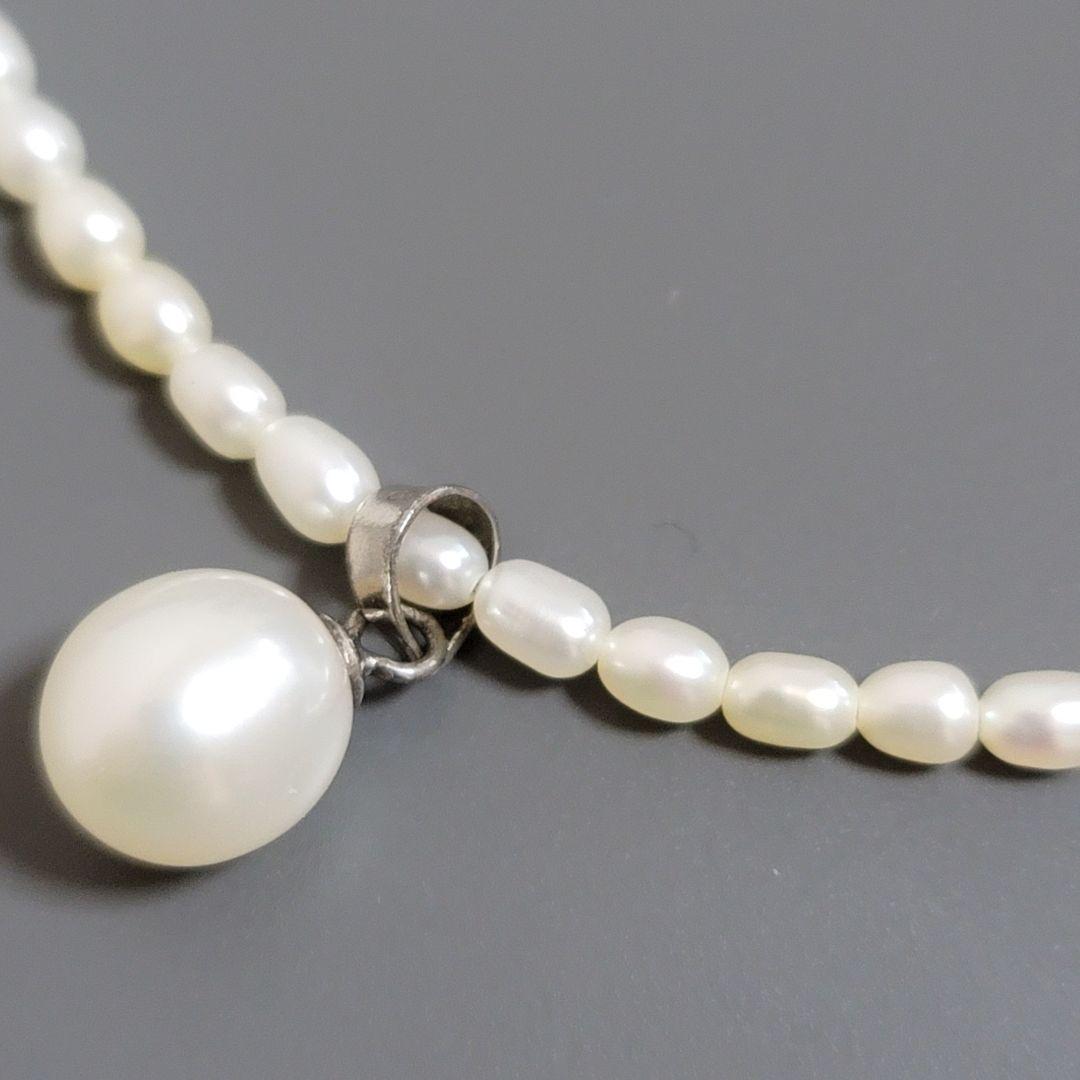 Suzunoya pearl necklace with small oval Akoya pearls and 925 silver clasp on white background