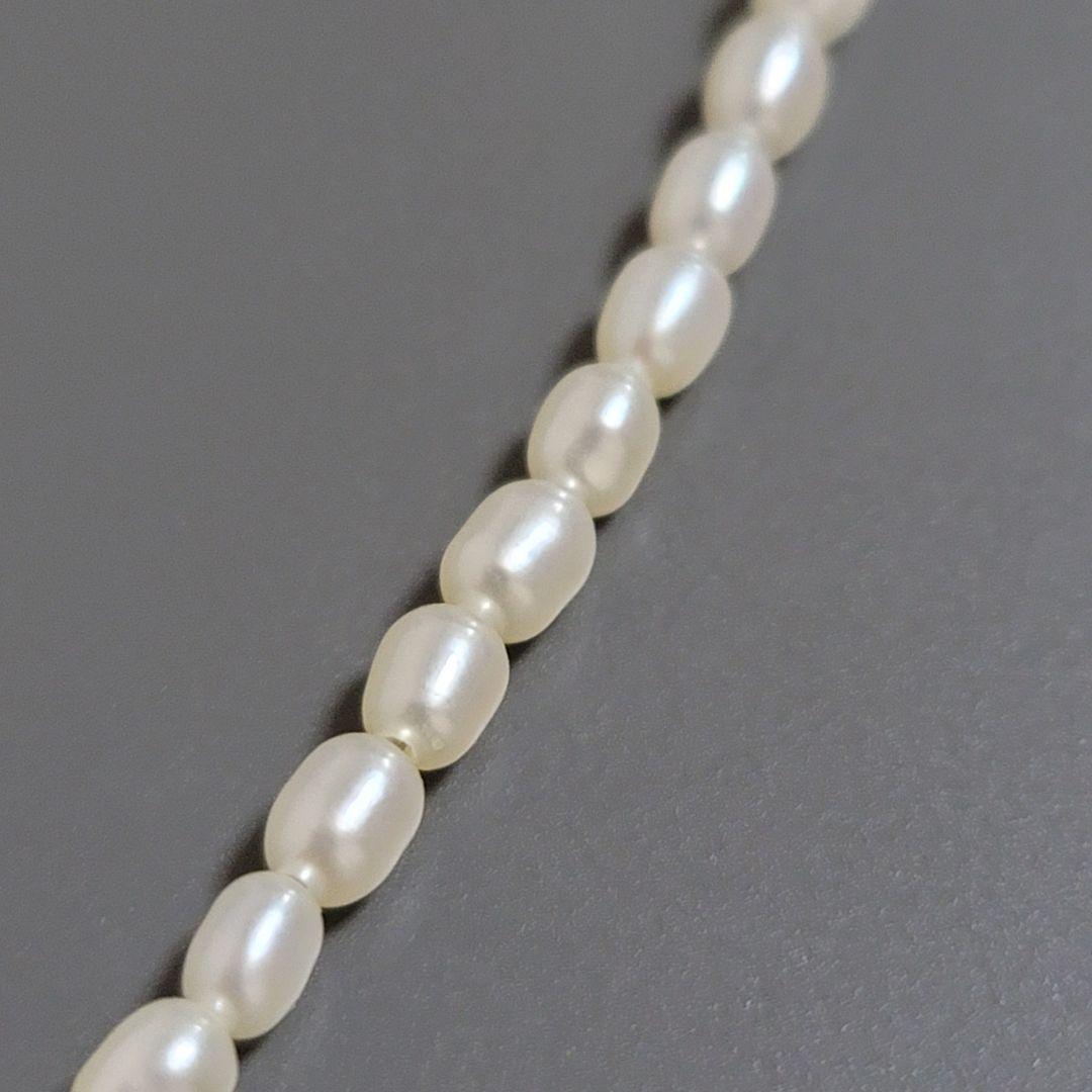 Suzunoya pearl necklace with small oval Akoya pearls and 925 silver clasp on white background