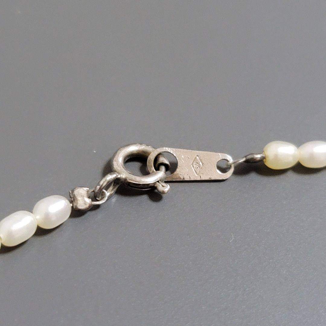 Suzunoya pearl necklace with small oval Akoya pearls and 925 silver clasp on white background