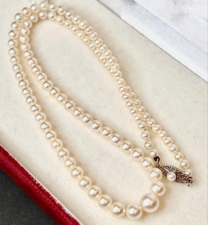 MIKIMOTO Gradient Necklace with cultured pearls ranging 3.6 to 7.0 mm and K10 metal clasp on a white background