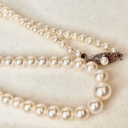 MIKIMOTO Gradient Necklace with cultured pearls ranging 3.6 to 7.0 mm and K10 metal clasp on a white background