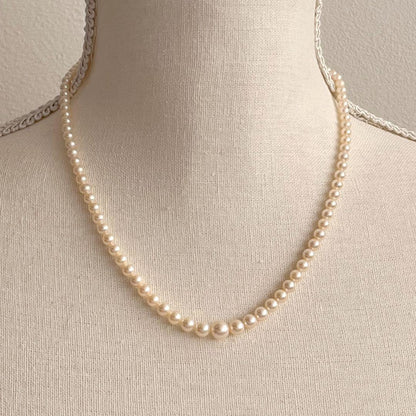 MIKIMOTO Gradient Necklace with cultured pearls ranging 3.6 to 7.0 mm and K10 metal clasp on a white background