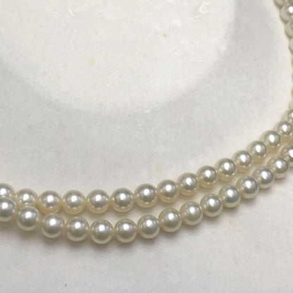 Takashi Akoya pearl two-strand necklace with silver clasp and 6-6.5 mm pearls on a white background
