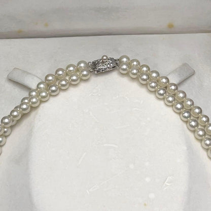 Takashi Akoya pearl two-strand necklace with silver clasp and 6-6.5 mm pearls on a white background