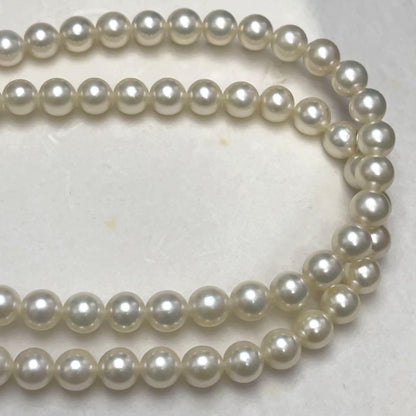 Takashi Akoya pearl two-strand necklace with silver clasp and 6-6.5 mm pearls on a white background