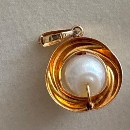 Law K18 Pearl pendant top featuring a ruby set in 18K gold with no chain or case included