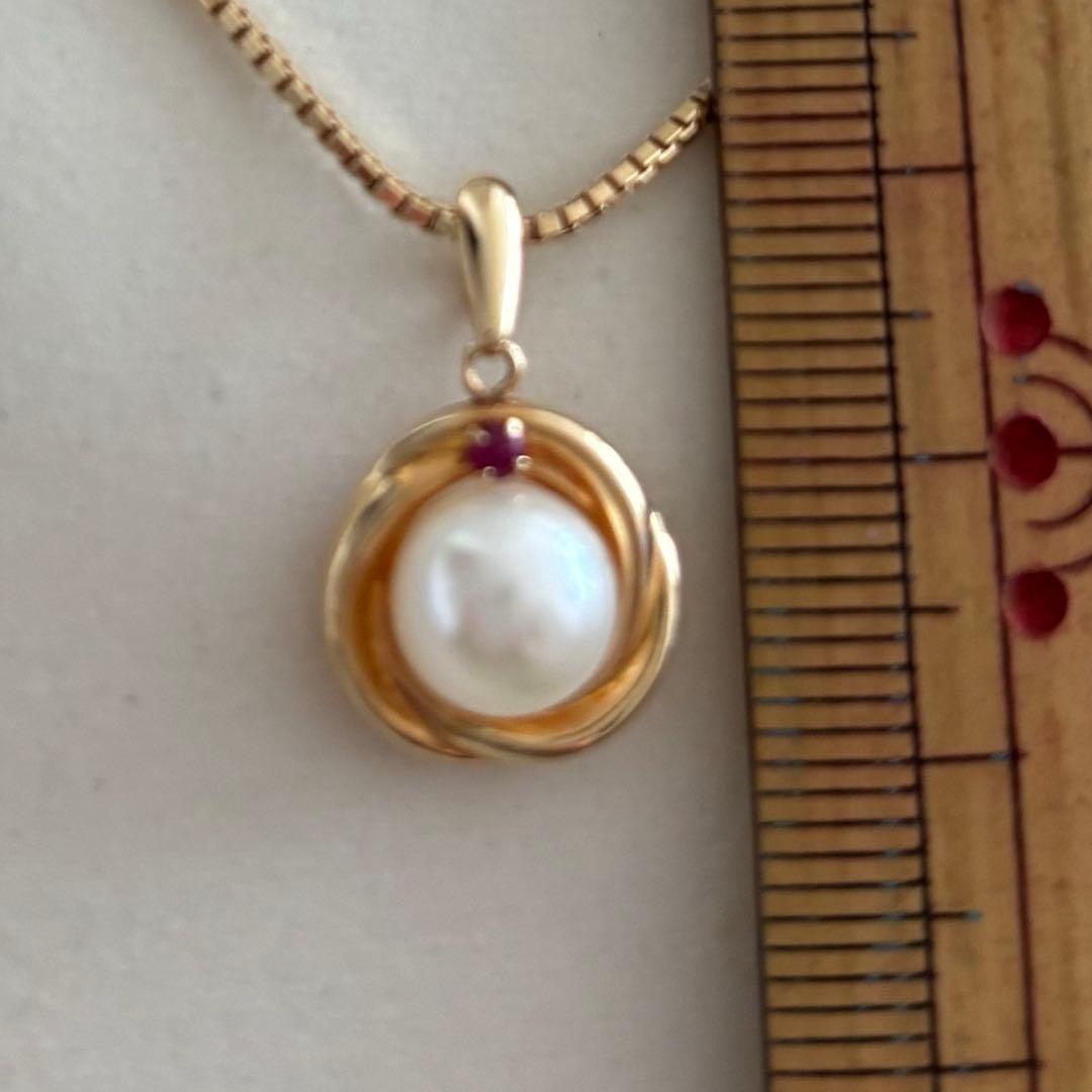 Law K18 Pearl pendant top featuring a ruby set in 18K gold with no chain or case included