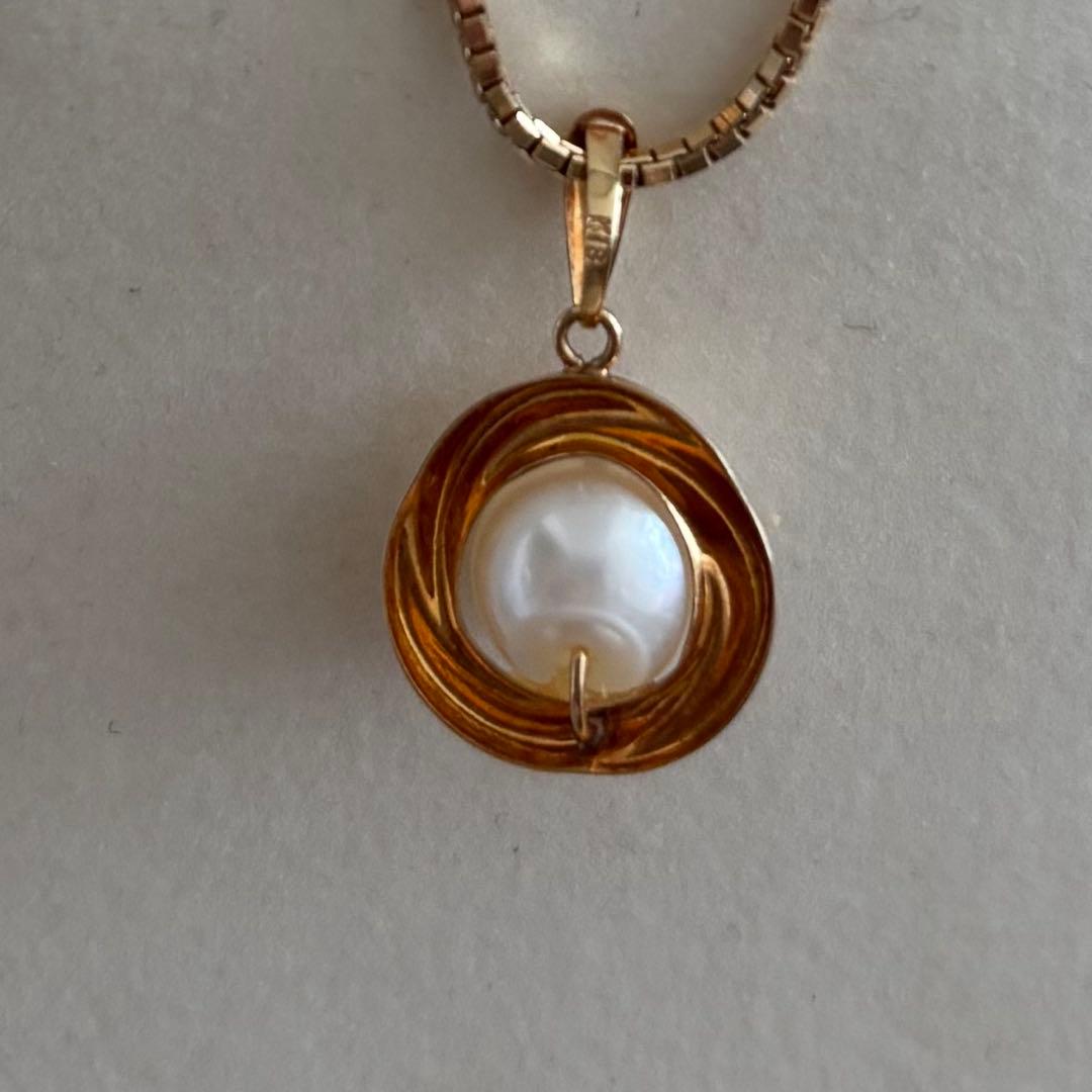 Law K18 Pearl pendant top featuring a ruby set in 18K gold with no chain or case included