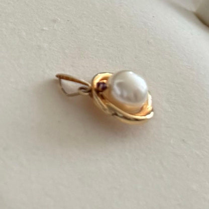 Law K18 Pearl pendant top featuring a ruby set in 18K gold with no chain or case included