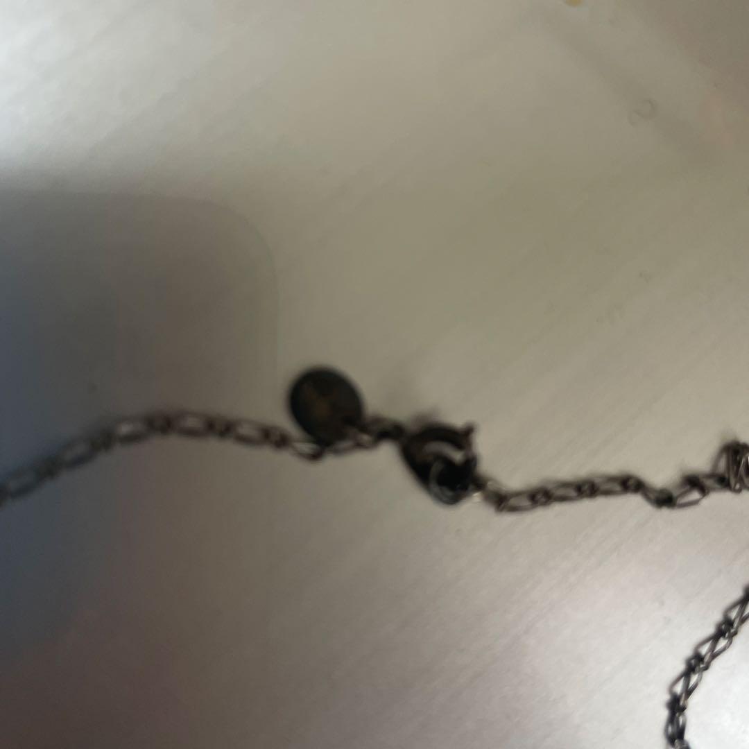 Agato silver pearl necklace with chain, beads, and charm on a white background