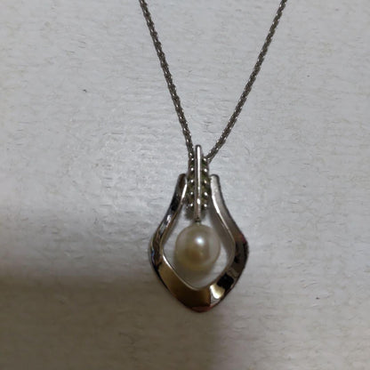 Mikimoto necklace featuring classic pearls in used condition with fine clasp and chain
