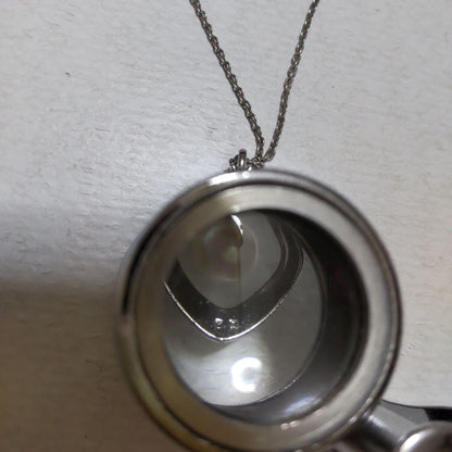 Mikimoto necklace featuring classic pearls in used condition with fine clasp and chain
