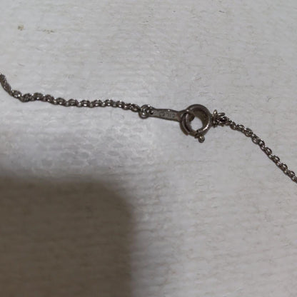 Mikimoto necklace featuring classic pearls in used condition with fine clasp and chain