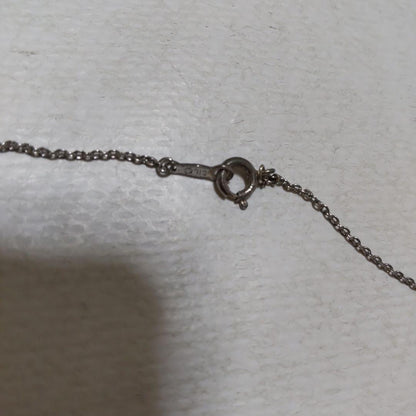 Mikimoto necklace featuring classic pearls in used condition with fine clasp and chain