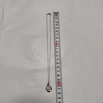 Mikimoto necklace featuring classic pearls in used condition with fine clasp and chain