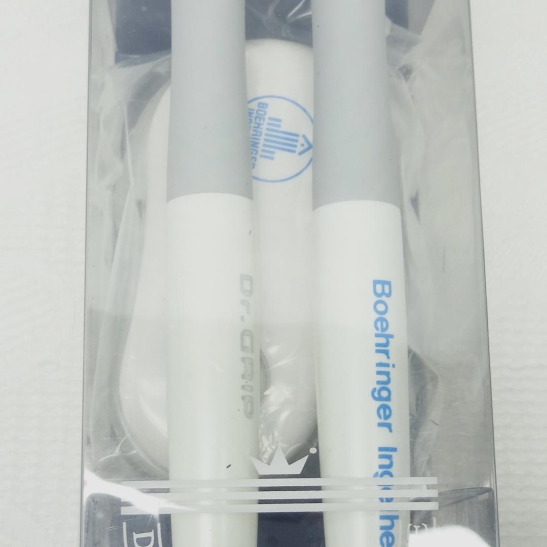 Dr.GRIP initial model ballpoint pen and mechanical pencil set with black desk stand on white background