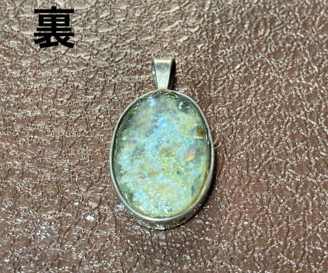 Silver pendant top with ancient Roman glass exhibiting an opal-like effect, measuring 1.3 cm by 2.5 cm