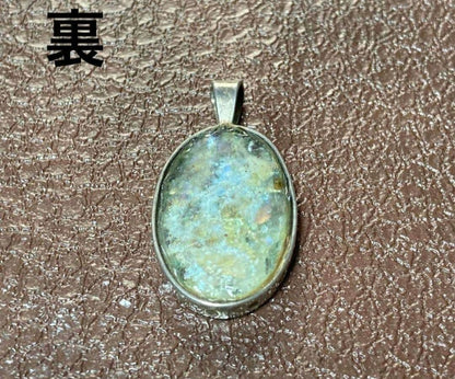Silver pendant top with ancient Roman glass exhibiting an opal-like effect, measuring 1.3 cm by 2.5 cm
