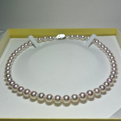 Akoya pearl necklace with 8-8.5 mm pearls and silver clasp on a white background