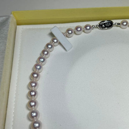 Akoya pearl necklace with 8-8.5 mm pearls and silver clasp on a white background