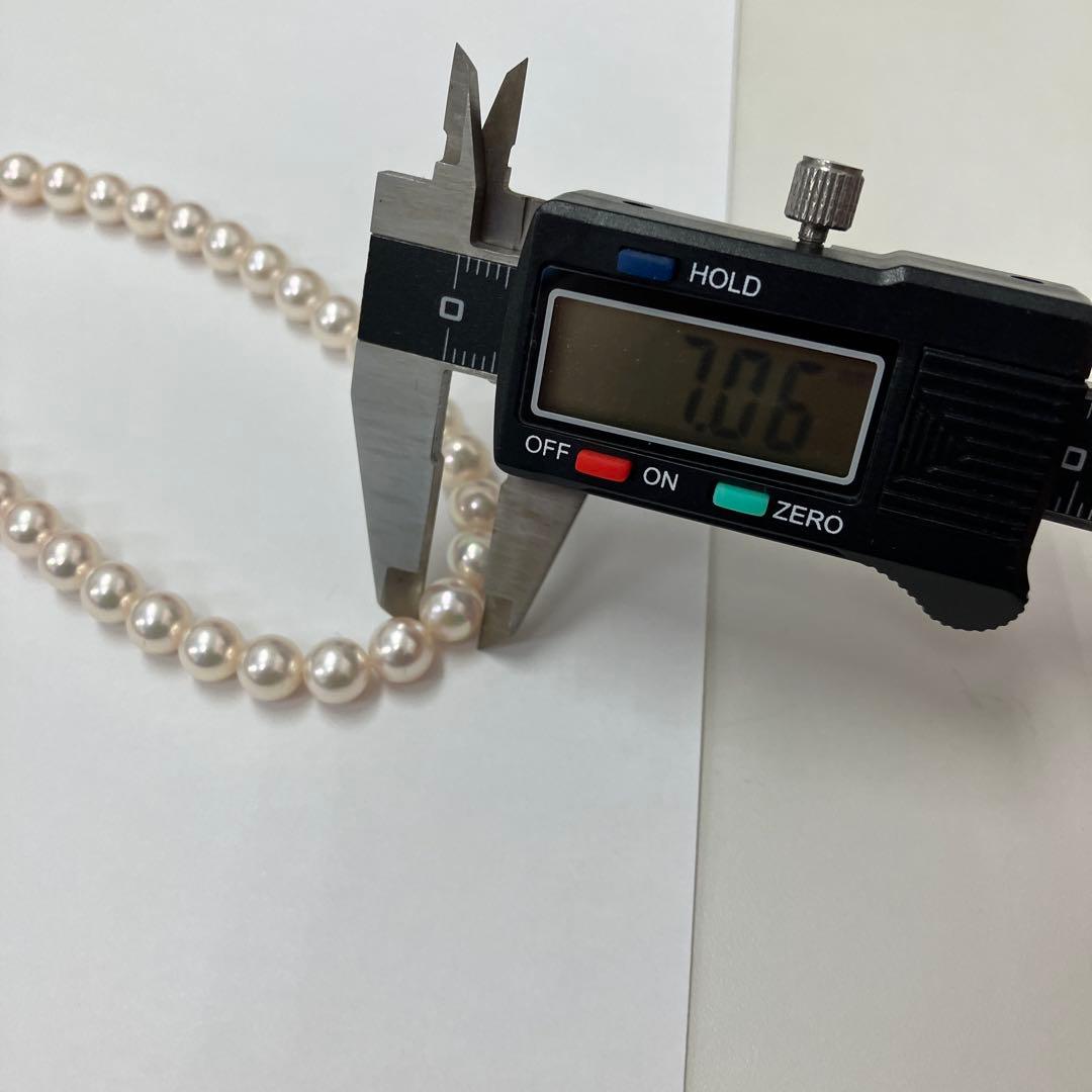 Akoya pearl necklace featuring 7.06mm pearls, six rubies, and a K14WG clasp on a 43cm chain