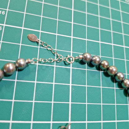 Akoya 6mm pearl Tahitian color necklace 37cm with matching titanium earrings displayed on white background