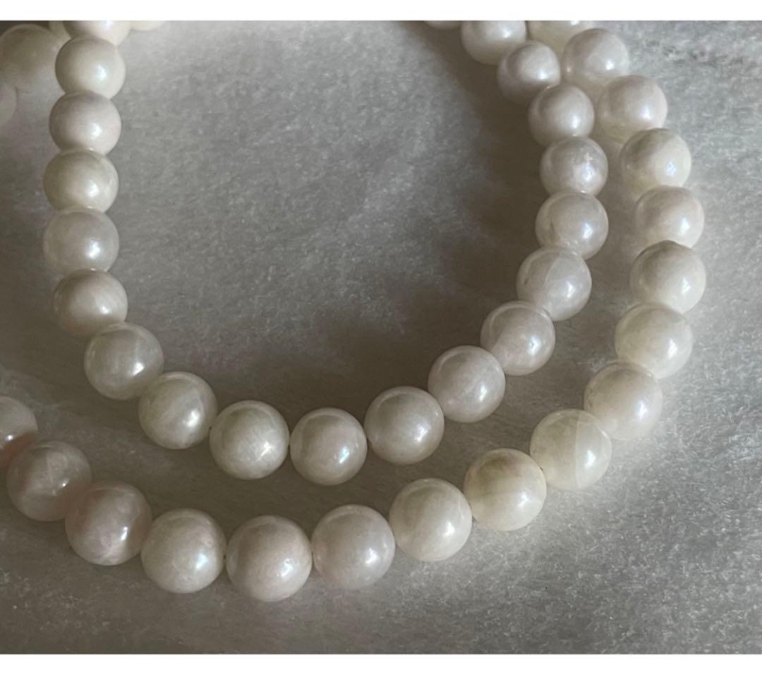 Akoya pearl necklace, earrings, and pendant set with 7mm pearls and silver clasp on white background