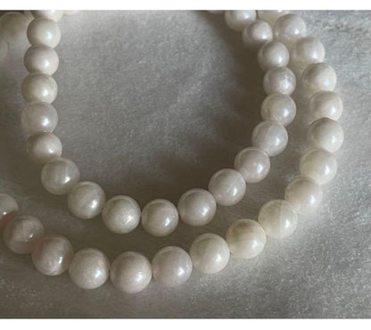 Akoya pearl necklace, earrings, and pendant set with 7mm pearls and silver clasp on white background
