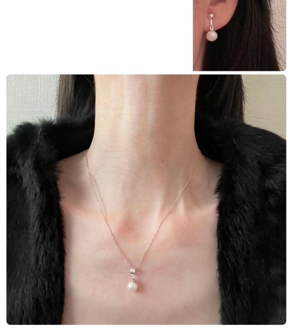 Akoya pearl necklace, earrings, and pendant set with 7mm pearls and silver clasp on white background