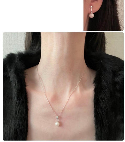 Akoya pearl necklace, earrings, and pendant set with 7mm pearls and silver clasp on white background