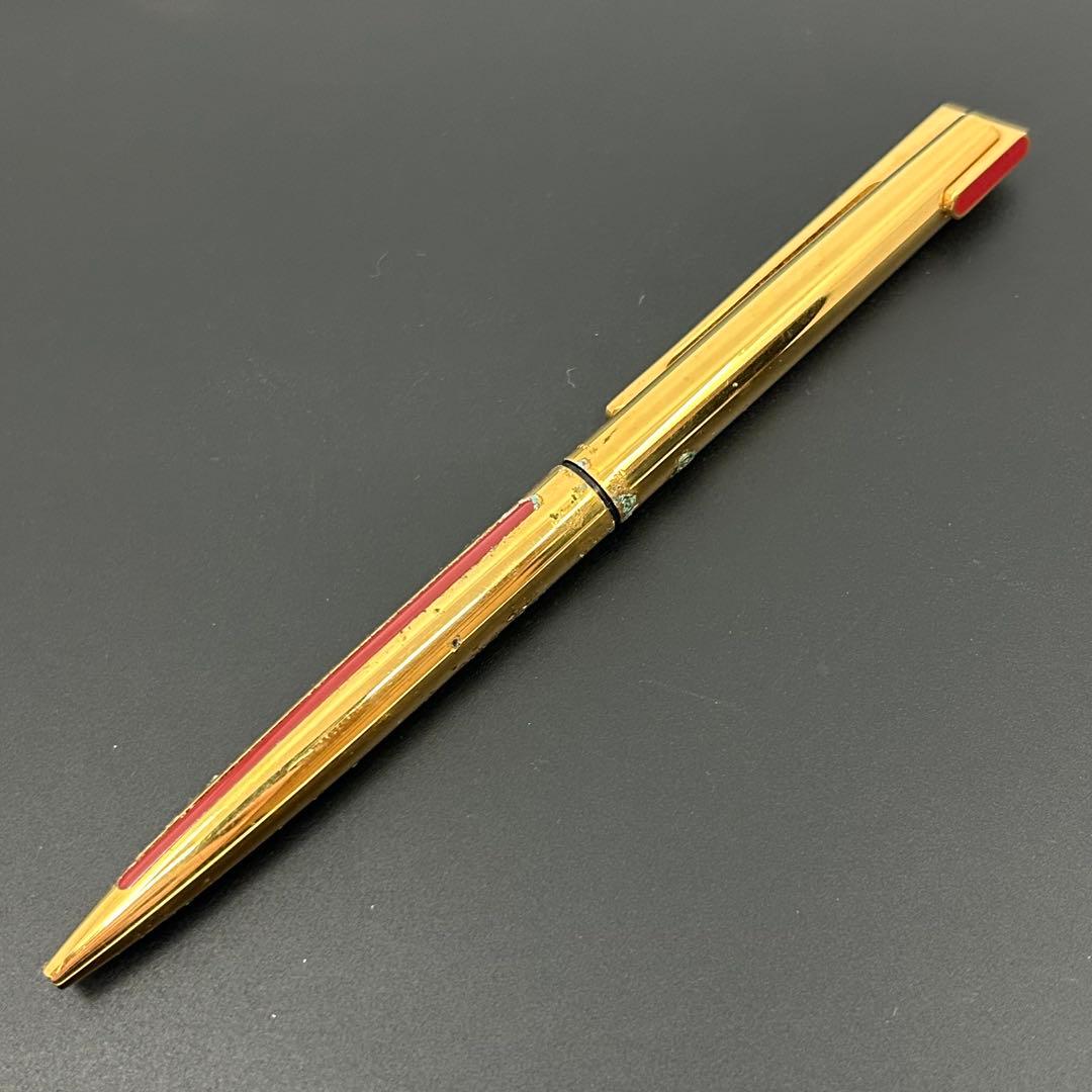 Vintage Waterman gold ballpoint pen in old condition with signs of wear and potential stains