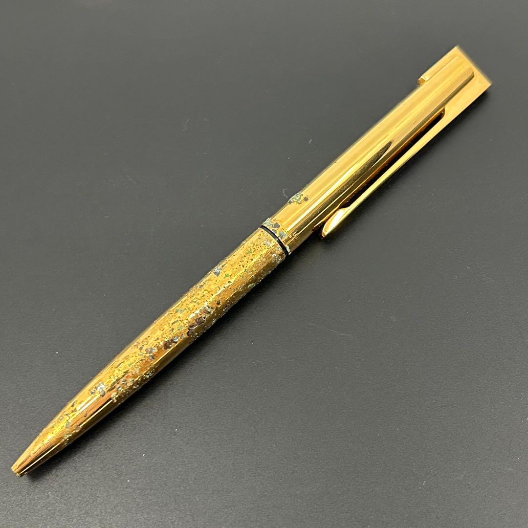 Vintage Waterman gold ballpoint pen in old condition with signs of wear and potential stains