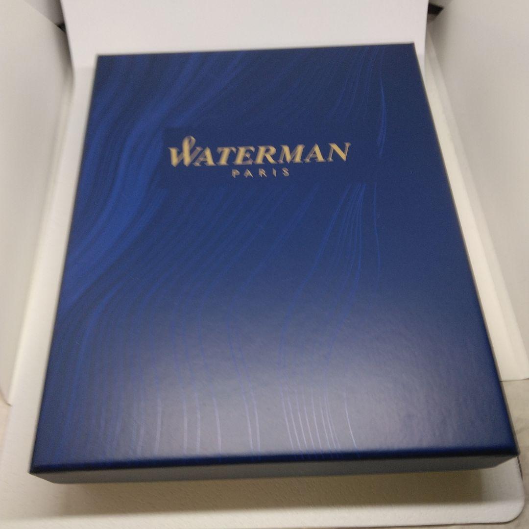 Waterman Expert silver ballpoint pen with black leather case on a white background