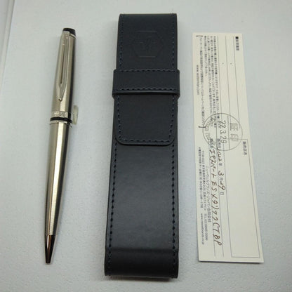 Waterman Expert silver ballpoint pen with black leather case on a white background
