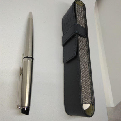 Waterman Expert silver ballpoint pen with black leather case on a white background