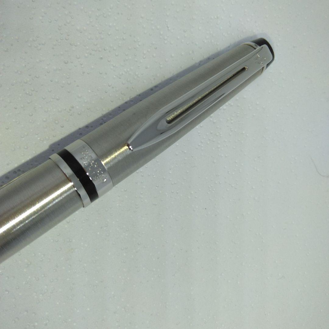 Waterman Expert silver ballpoint pen with black leather case on a white background