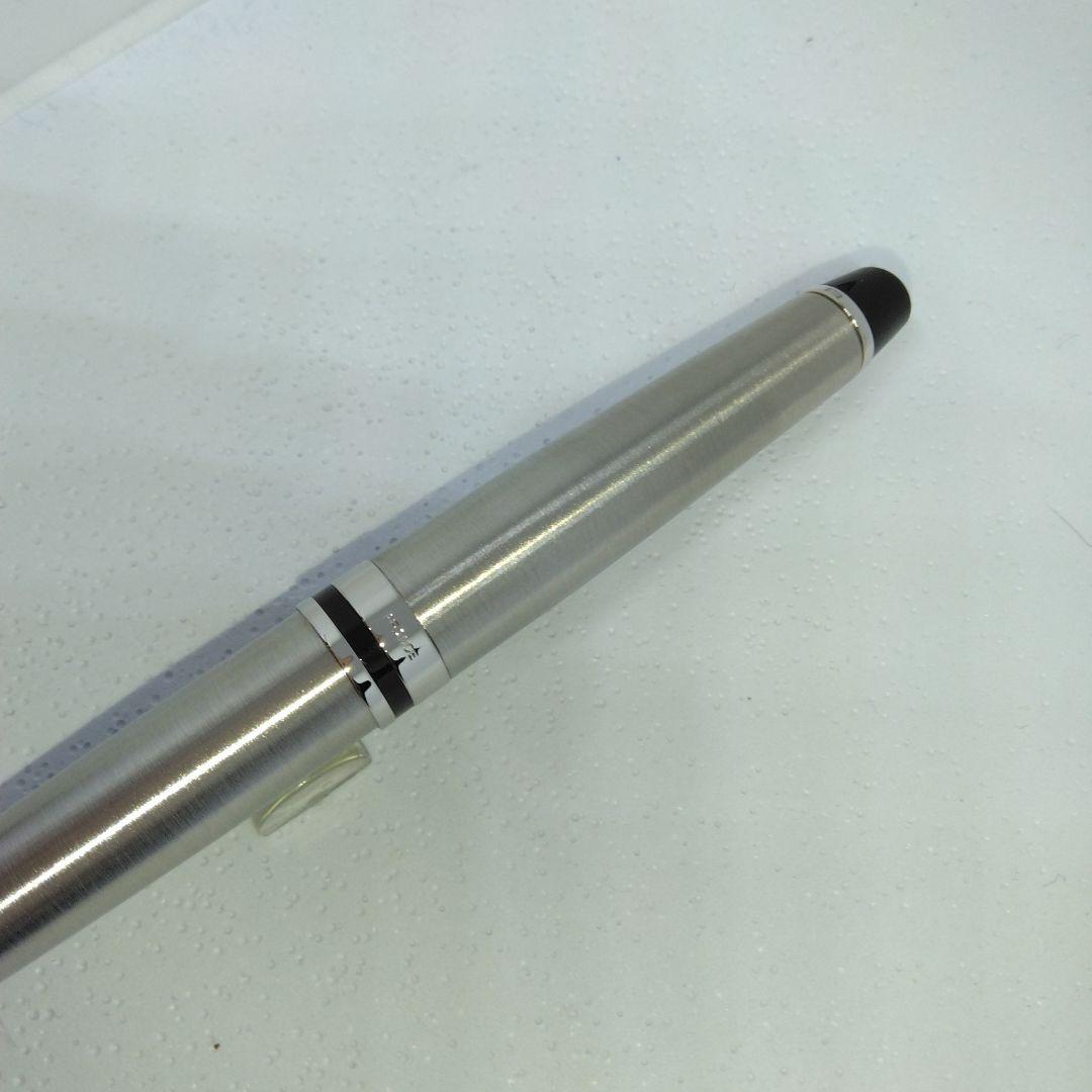 Waterman Expert silver ballpoint pen with black leather case on a white background