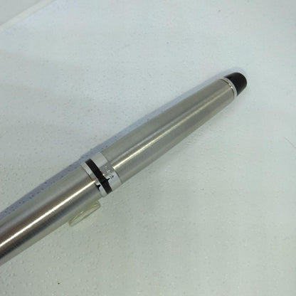 Waterman Expert silver ballpoint pen with black leather case on a white background