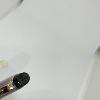 Waterman Expert silver ballpoint pen with black leather case on a white background