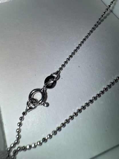 Tasaki silver necklace with a pearl pendant and lobster clasp displayed with a dedicated case