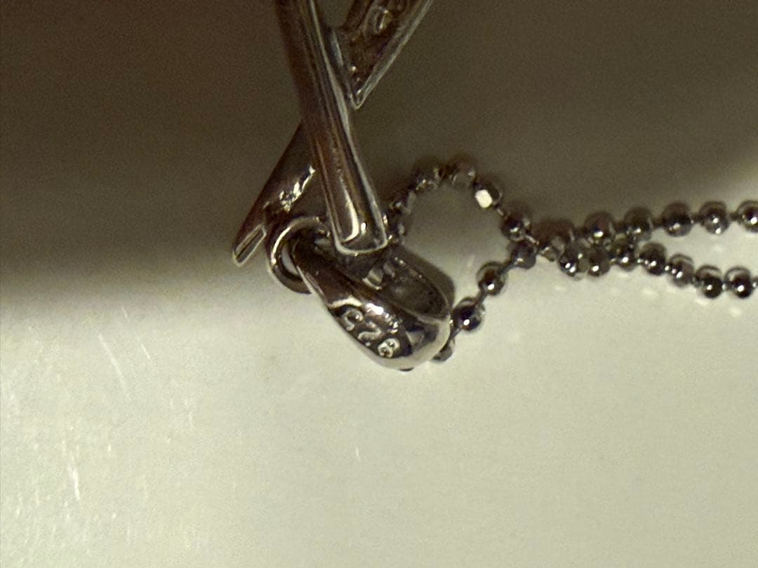 Tasaki silver necklace with a pearl pendant and lobster clasp displayed with a dedicated case
